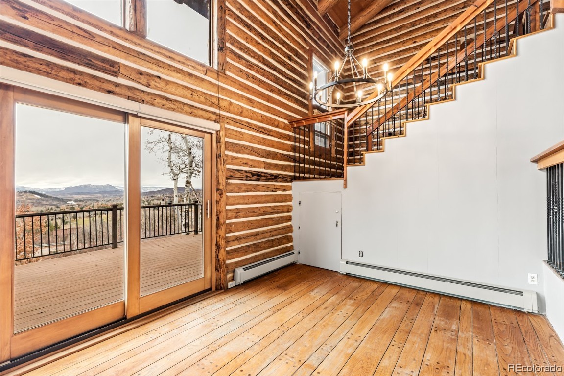 1527 Natches Road Steamboat Springs, CO 80487 - Photo 4 of 50 a view of a room with wooden floor and large windows