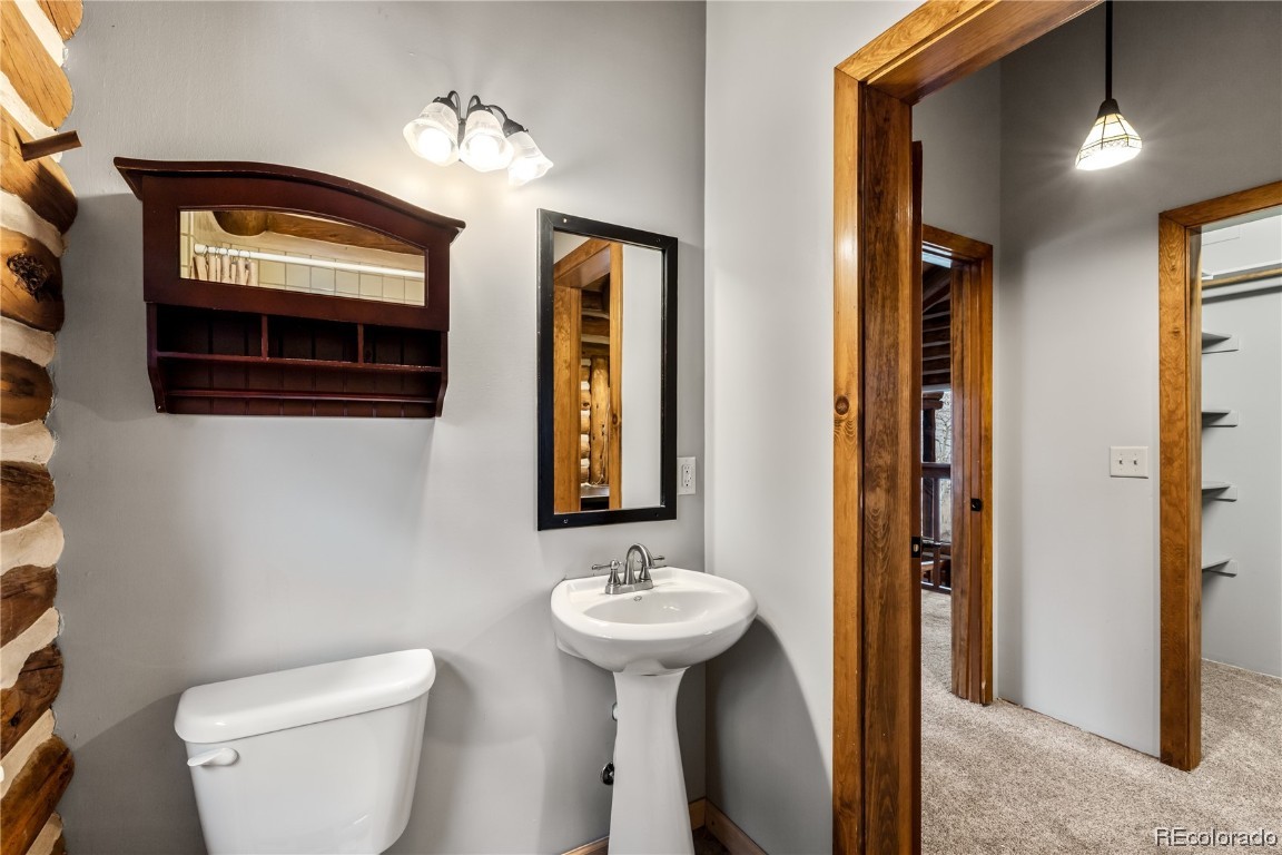 1527 Natches Road Steamboat Springs, CO 80487 - Photo 44 of 50 a bathroom with a toilet sink and mirror