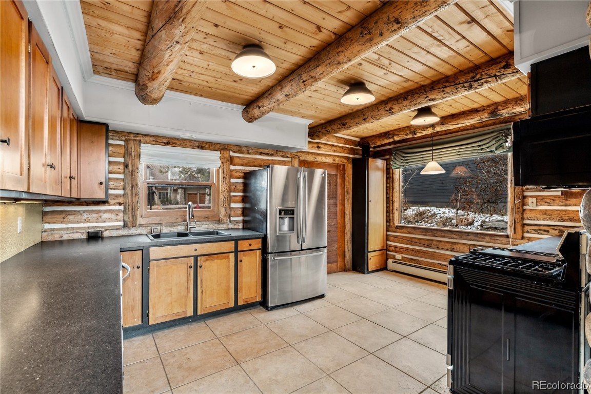 1527 Natches Road Steamboat Springs, CO 80487 - Photo 10 of 50 a kitchen with stainless steel appliances granite countertop a refrigerator and a stove top oven