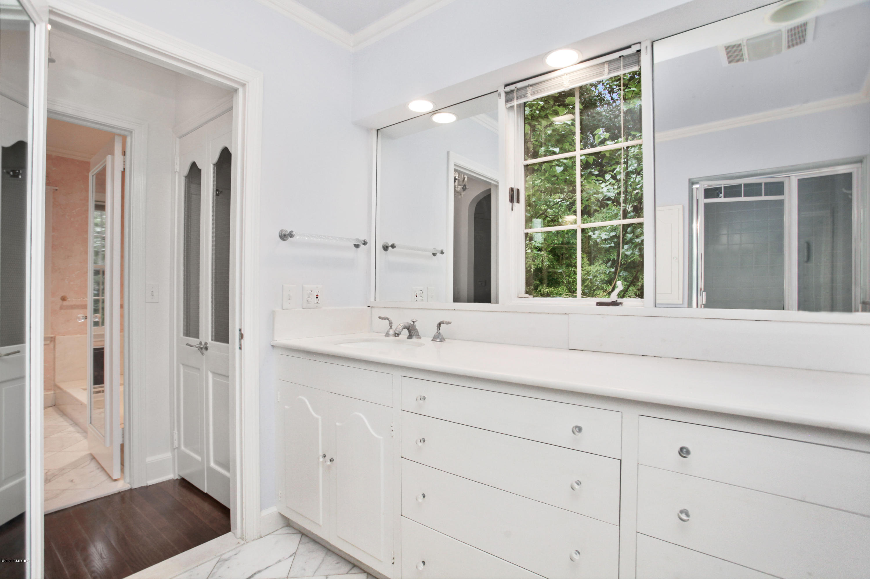 155 Clapboard Ridge Road Greenwich, CT 06831 - Photo 17 of 24 a bathroom with a sink and a large mirror
