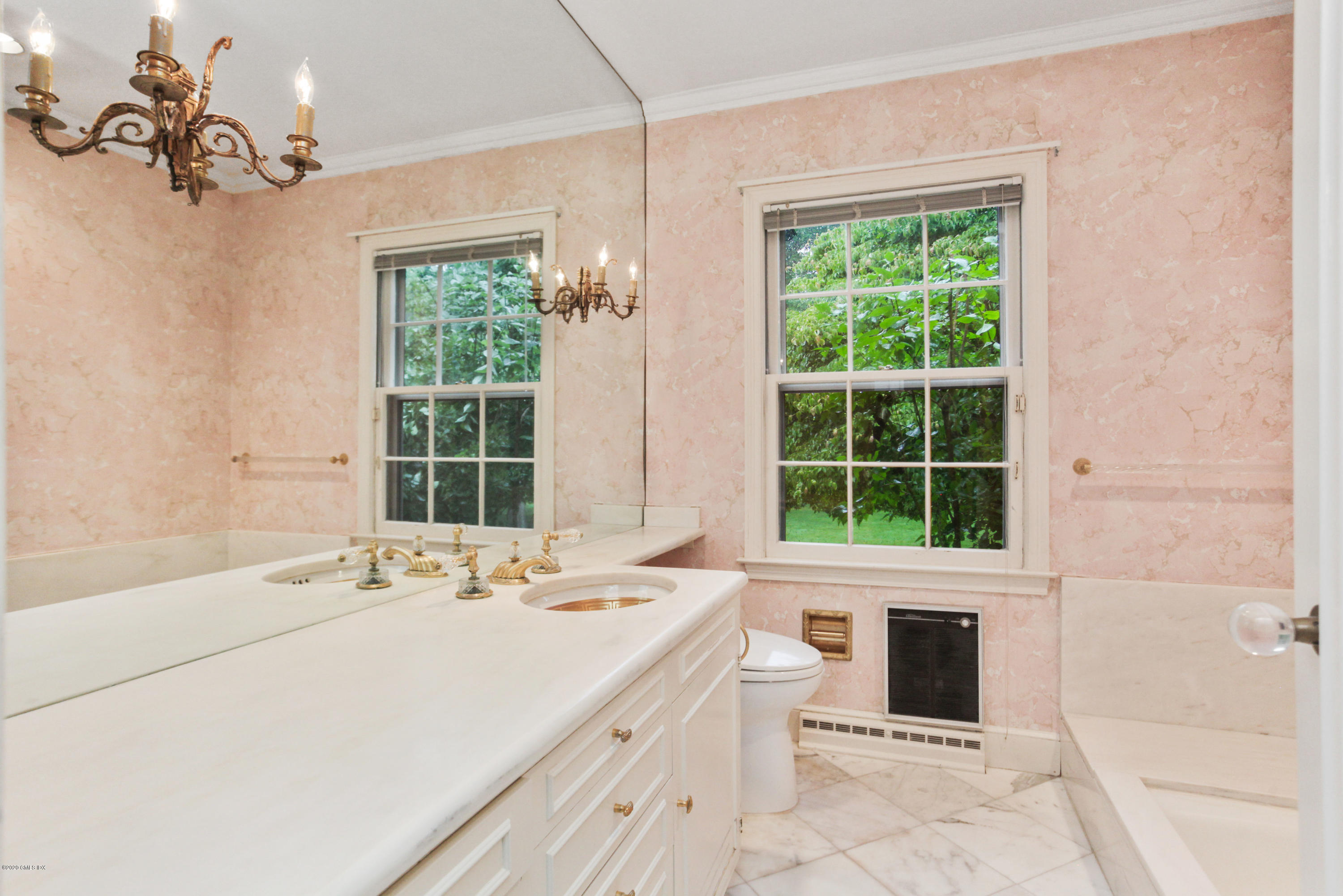 155 Clapboard Ridge Road Greenwich, CT 06831 - Photo 18 of 24 a bathroom with a tub sink and a window