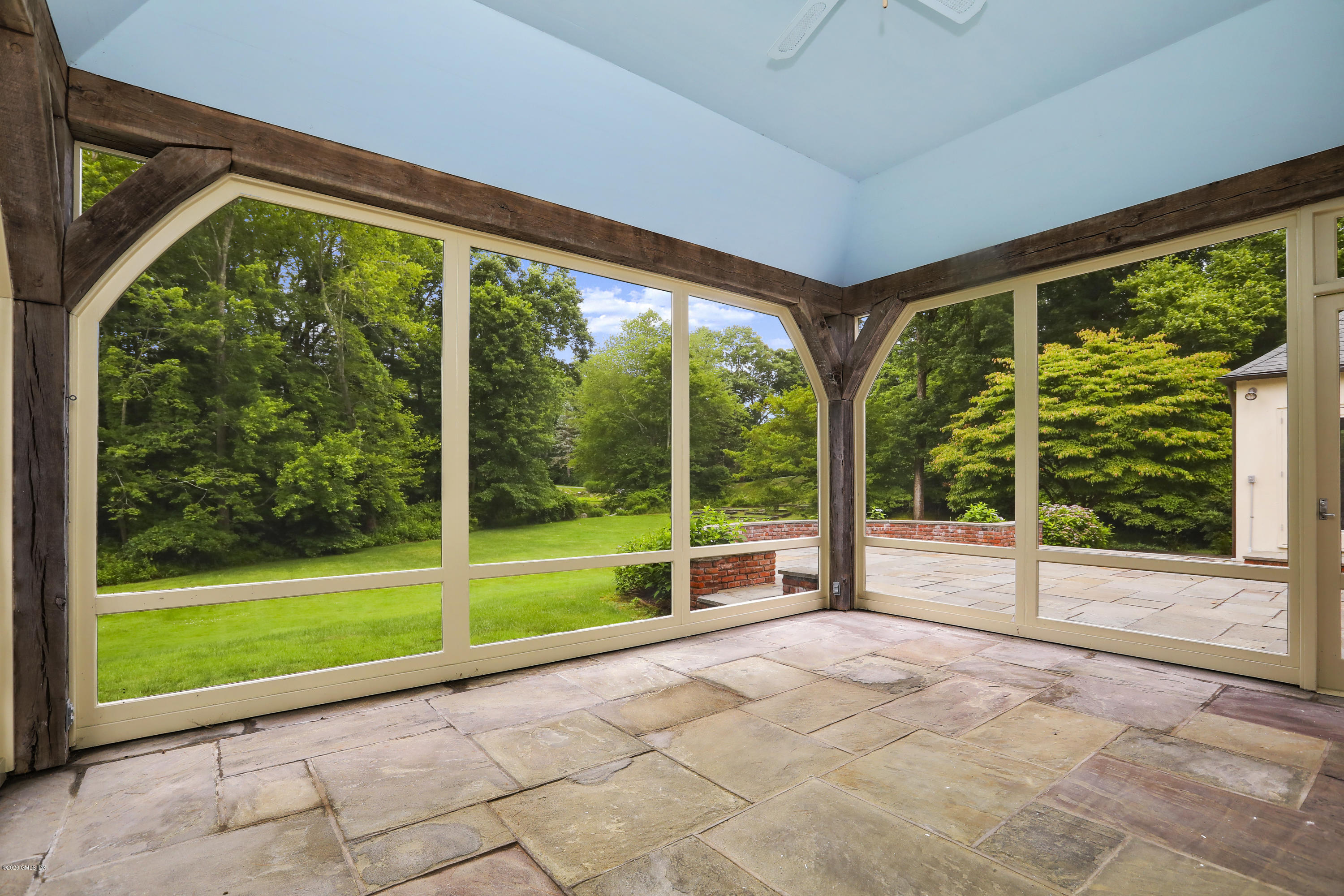 155 Clapboard Ridge Road Greenwich, CT 06831 - Photo 22 of 24 a view of a room with porch and a yard