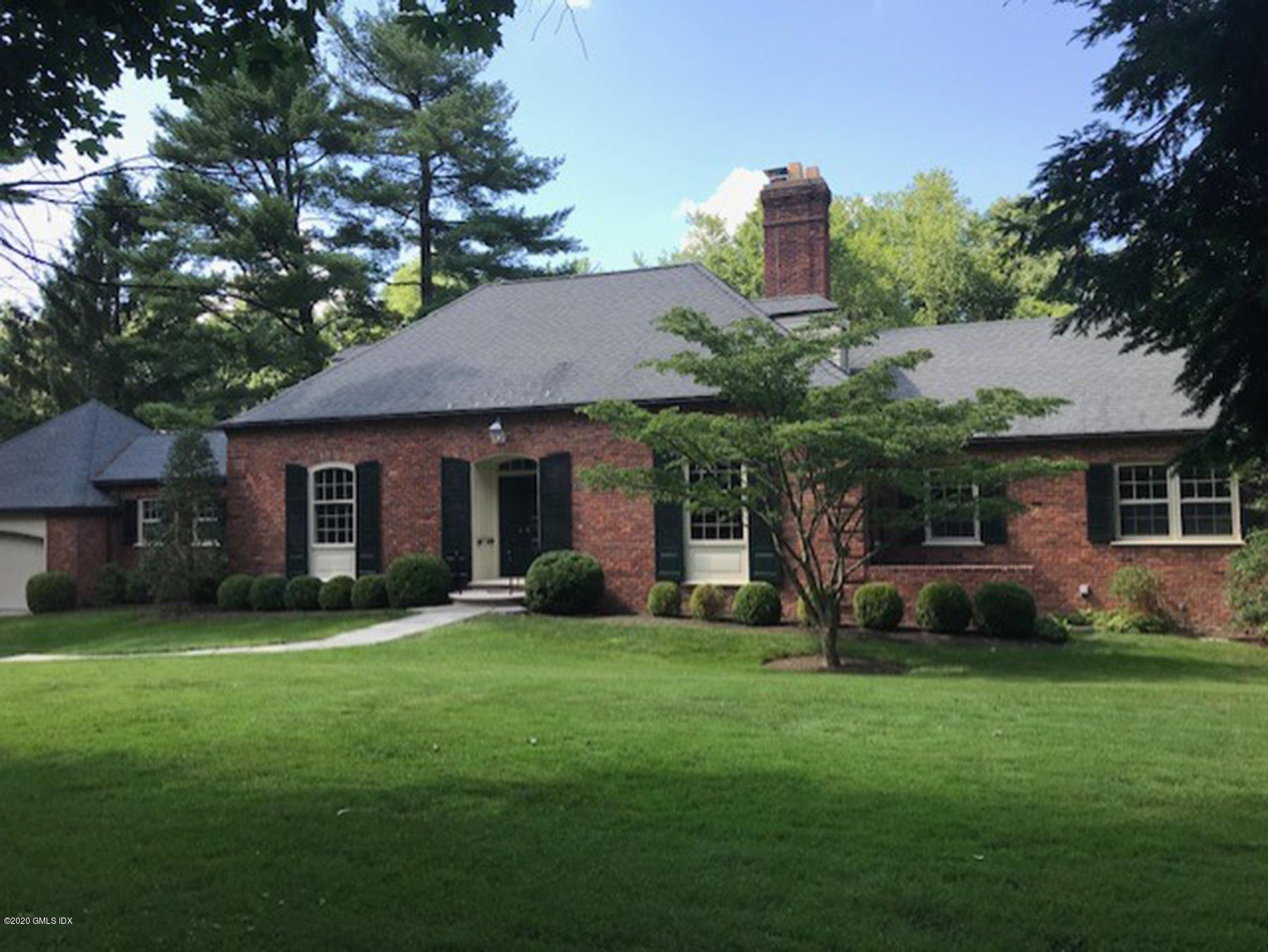 155 Clapboard Ridge Road Greenwich, CT 06831 - Photo 3 of 24 a front view of a house with a yard and tree