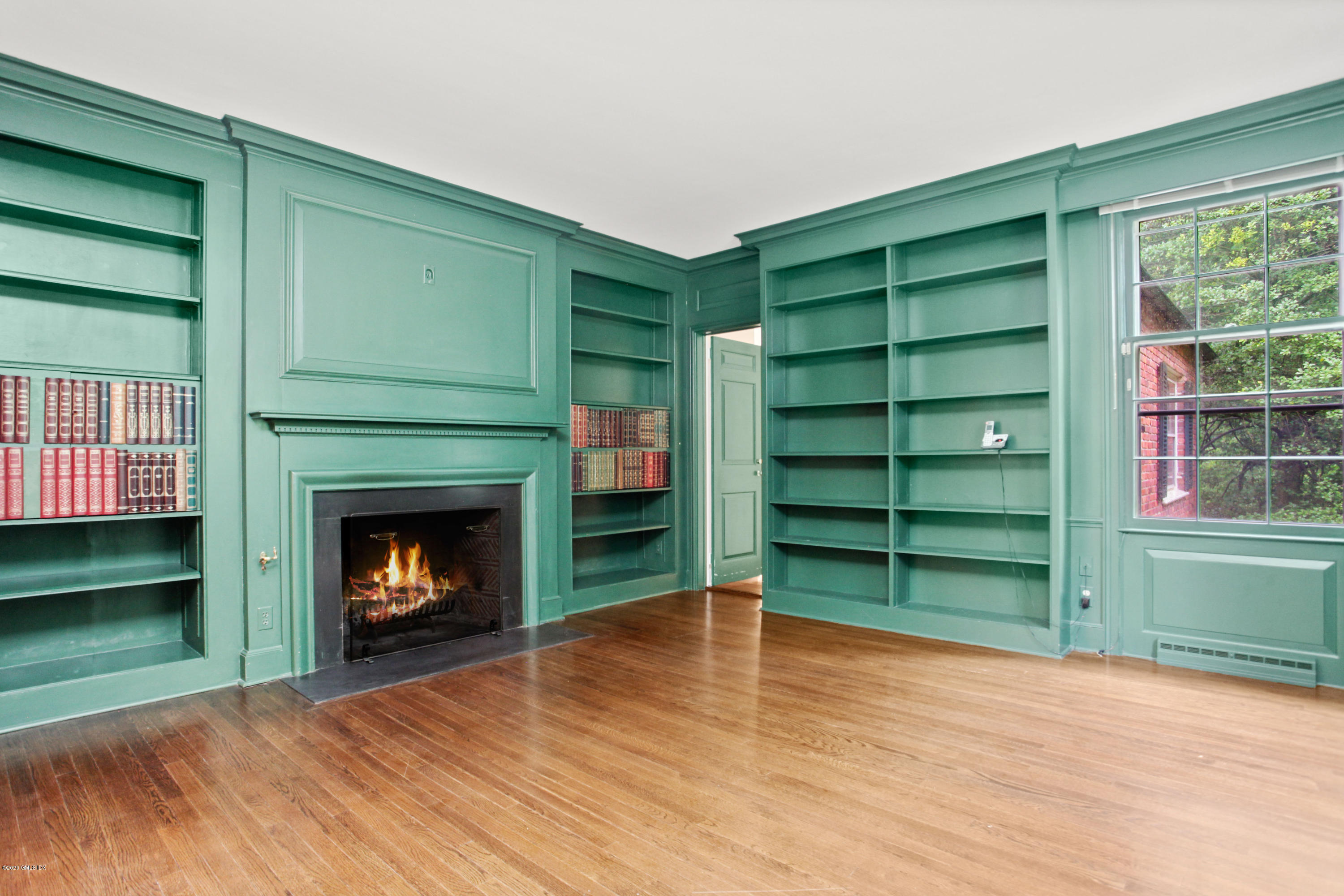 155 Clapboard Ridge Road Greenwich, CT 06831 - Photo 8 of 24 a room with a fireplace and a wooden floor