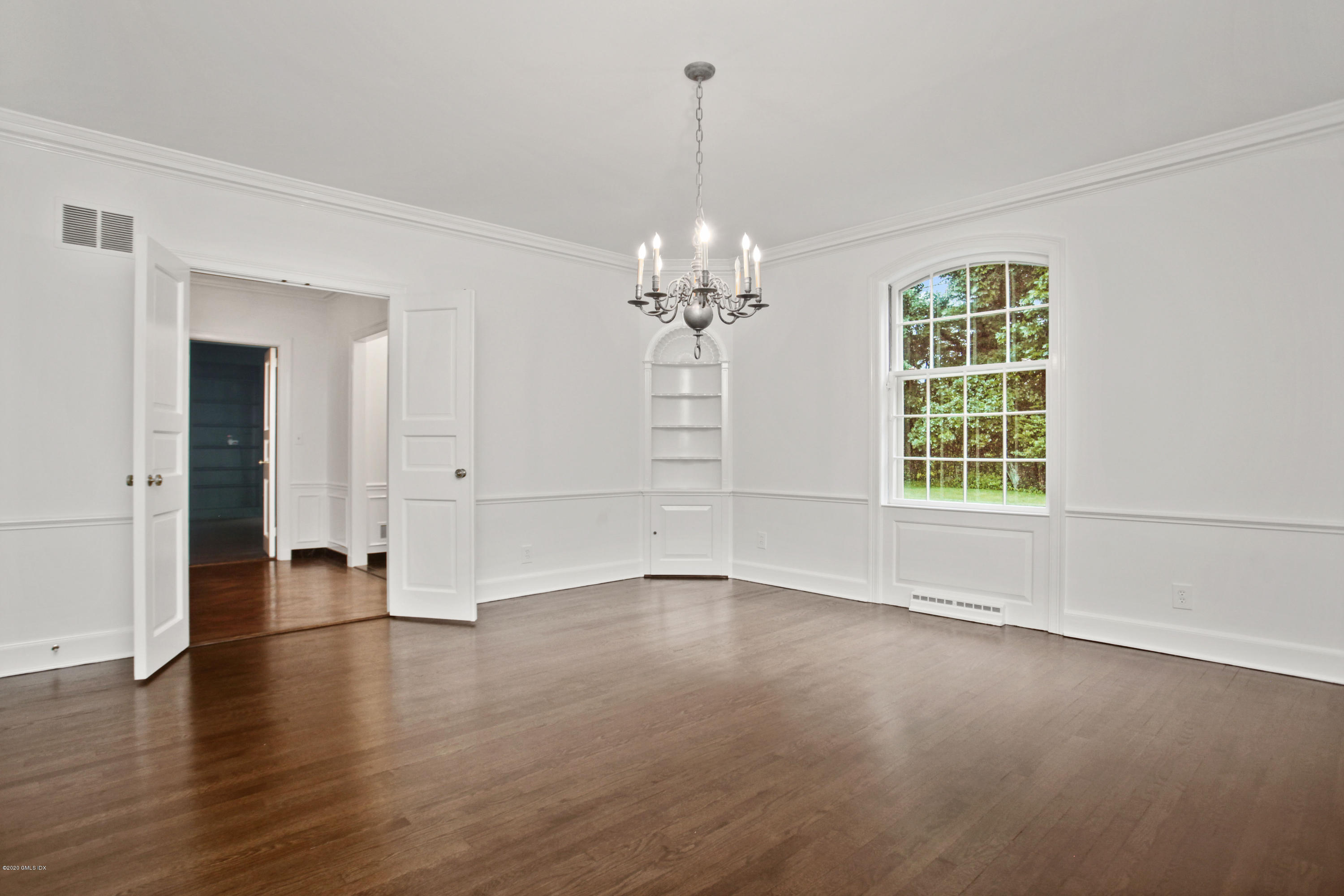 155 Clapboard Ridge Road Greenwich, CT 06831 - Photo 9 of 24 an empty room with wooden floor and windows