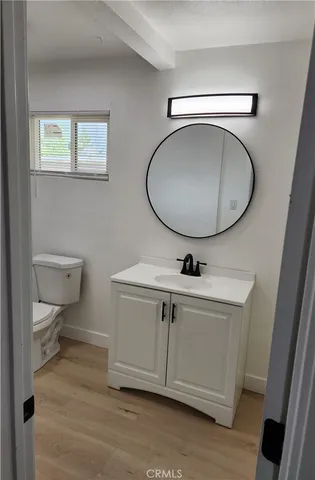 a bathroom with a toilet a sink and mirror