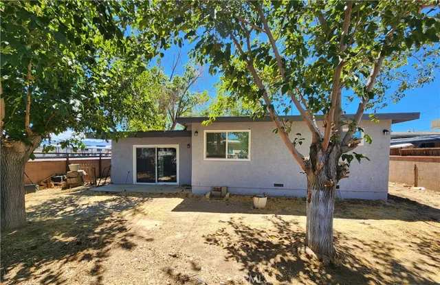 a view of a yard with wooden fence
