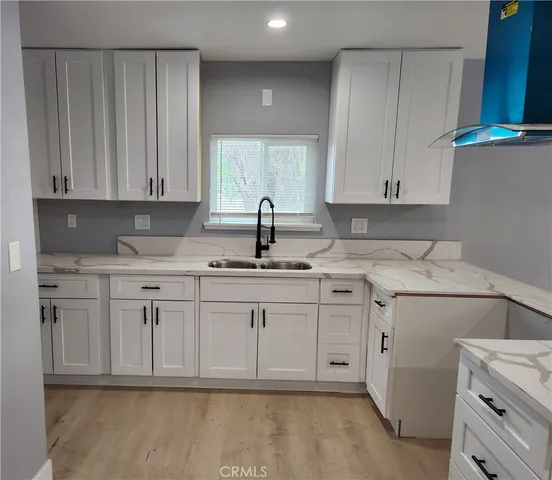 a kitchen with cabinets appliances and a counter top