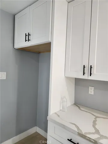 a view of kitchen with cabinets