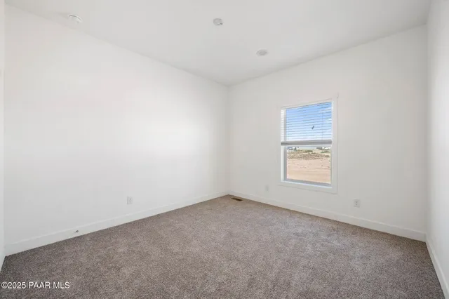 a view of an empty room and a window