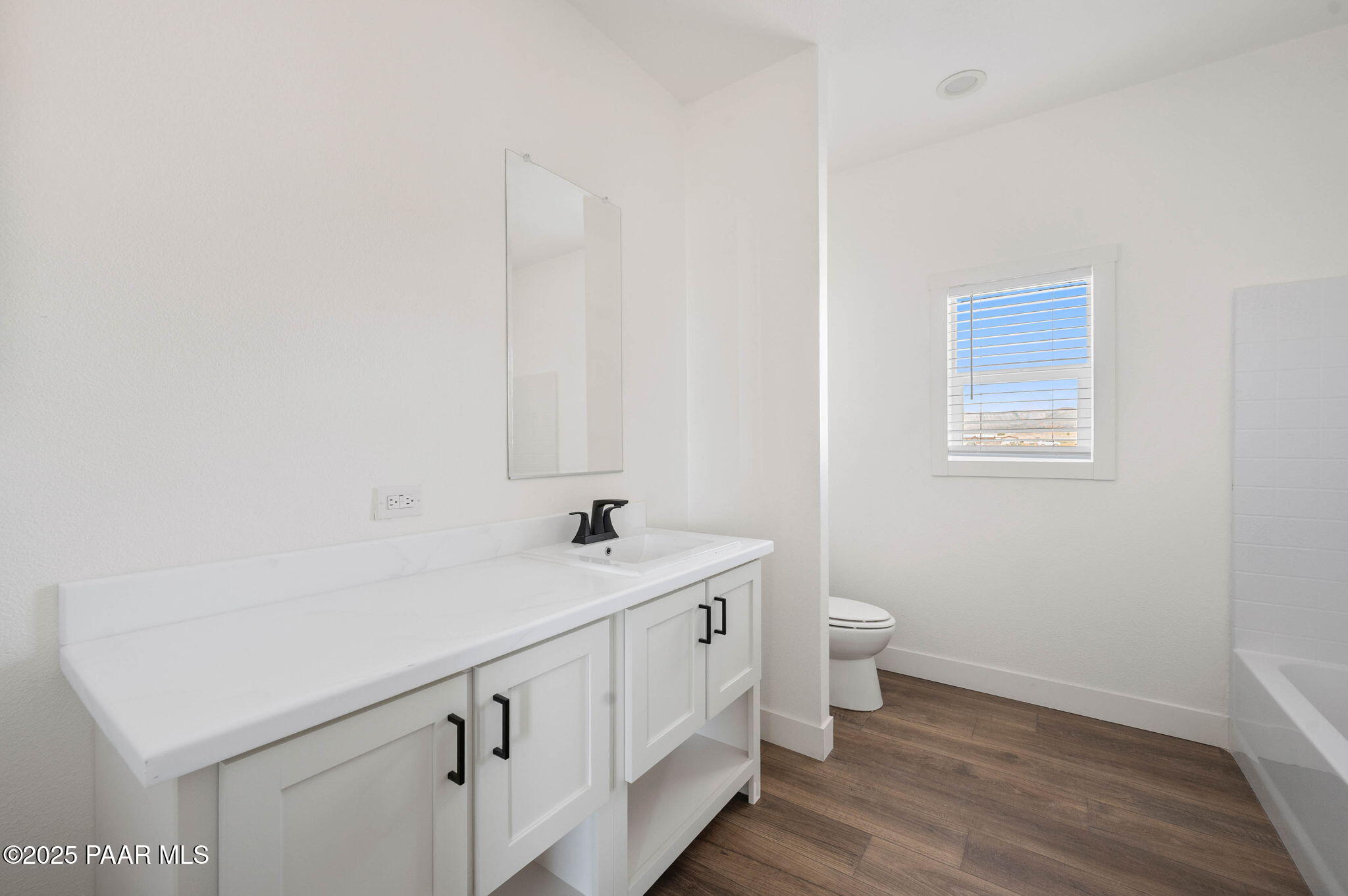 2758 West Altimeter Way Paulden, AZ 86334 - Photo 16 of 24 a bathroom with a sink a toilet and a window