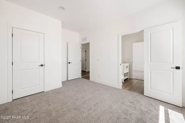 a view of a room with a wardrobe space and a bathroom