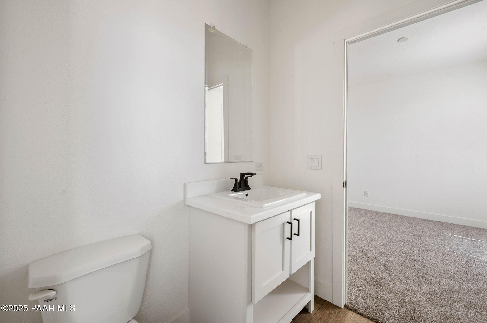 2758 West Altimeter Way Paulden, AZ 86334 - Photo 18 of 24 a bathroom with a toilet sink and mirror