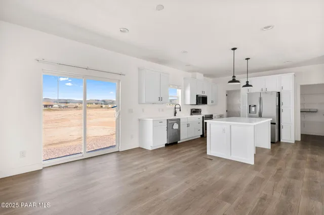 a view of a kitchen with wooden floor