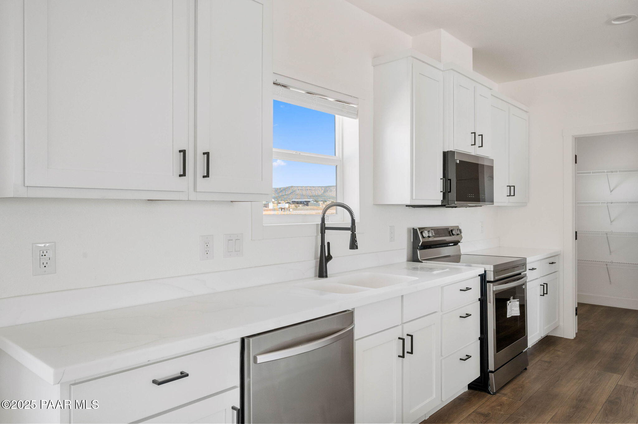 2758 West Altimeter Way Paulden, AZ 86334 - Photo 7 of 24 a kitchen with stainless steel appliances granite countertop a sink a stove a microwave and wooden cabinets