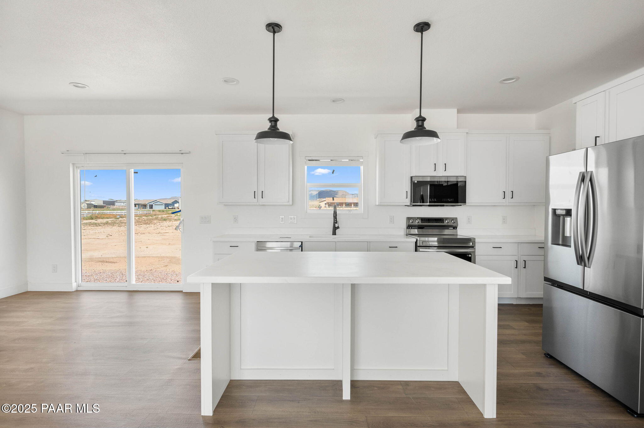 2758 West Altimeter Way Paulden, AZ 86334 - Photo 8 of 24 a kitchen with stainless steel appliances a sink a refrigerator a center island a stove and cabinets
