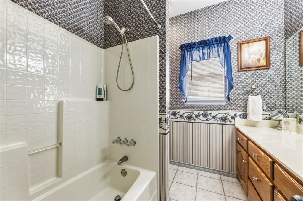 130 Blazek Road Alma, TX 75119 - Photo 22 of 34 a bathroom with a tub sink a mirror and shower