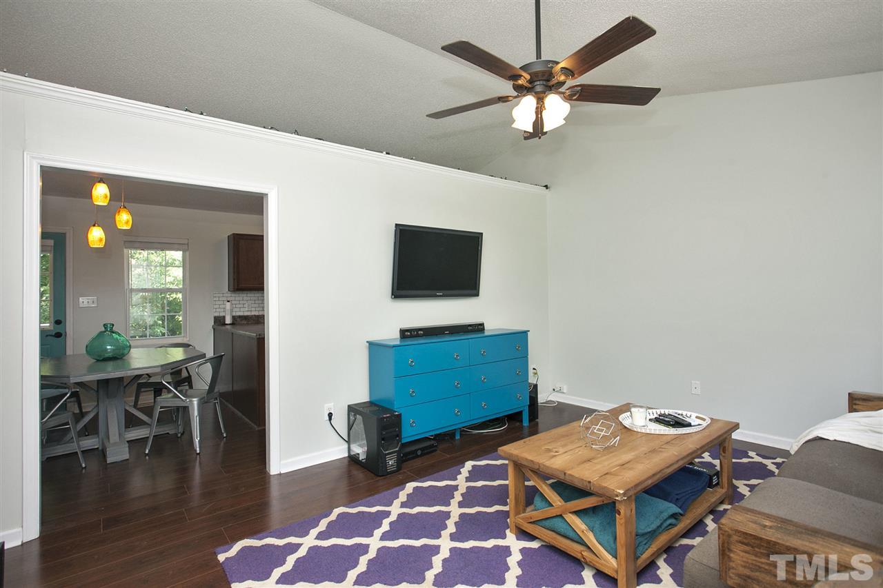 1145 Marlborough Road Raleigh, NC 27610 - Photo 2 of 17 a living room with furniture and a flat screen tv