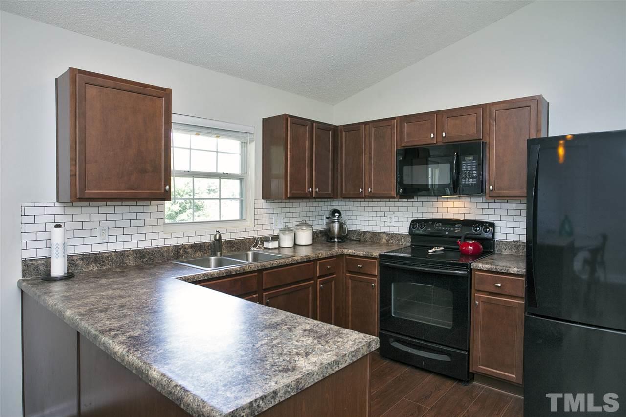 1145 Marlborough Road Raleigh, NC 27610 - Photo 6 of 17 a kitchen with granite countertop a sink stove and refrigerator