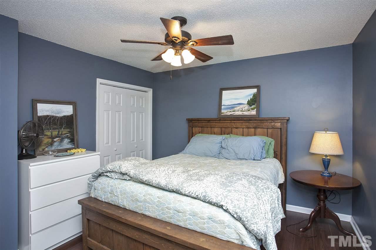 1145 Marlborough Road Raleigh, NC 27610 - Photo 10 of 17 a bedroom with a bed and a lamp on dresser