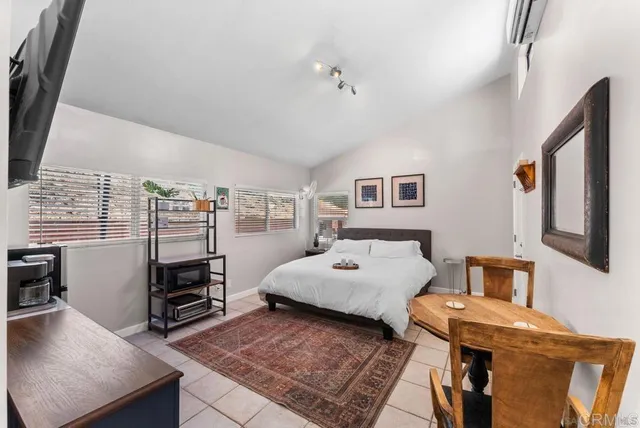a bedroom with furniture and a flat screen tv