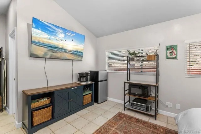 a room with furniture a air conditioner and a window