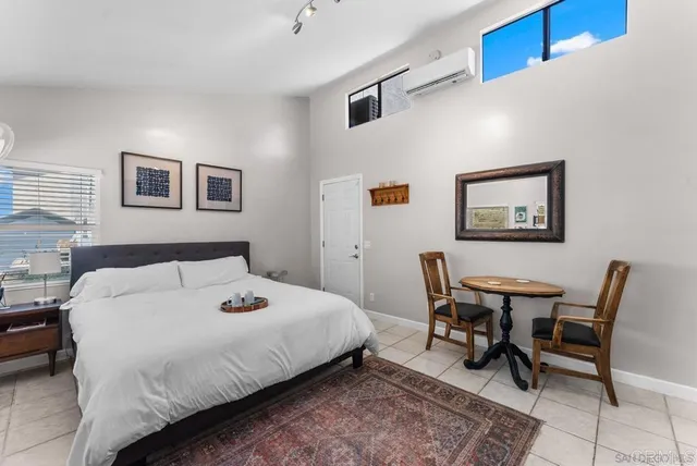 a bedroom with a bed and a desk