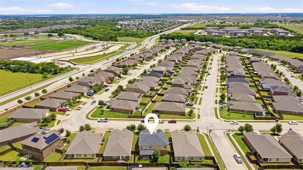 806 Silver Street Princeton, TX 75407 - Photo 9 of 29 Aerial perspective showcasing a residential neighborhood with single-family homes, organized along paved streets with sidewalks