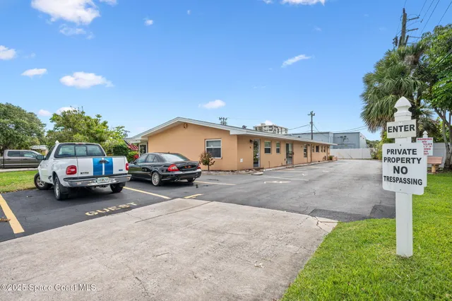 a view of a car park in front of a house