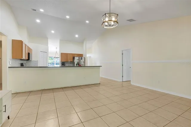 a view of a kitchen with kitchen island granite countertop stainless steel appliances cabinets a sink and a counter top