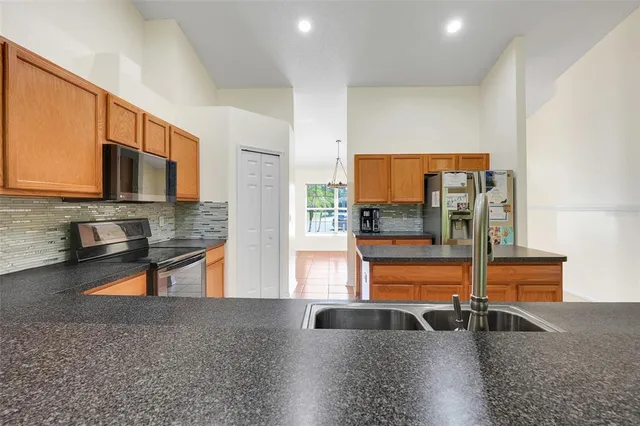 a kitchen with stainless steel appliances granite countertop a sink and a microwave