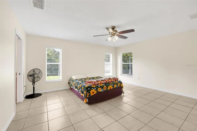 a living room with a large bed and a window