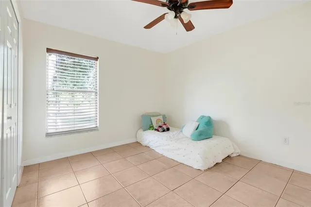a bedroom with a bed and window