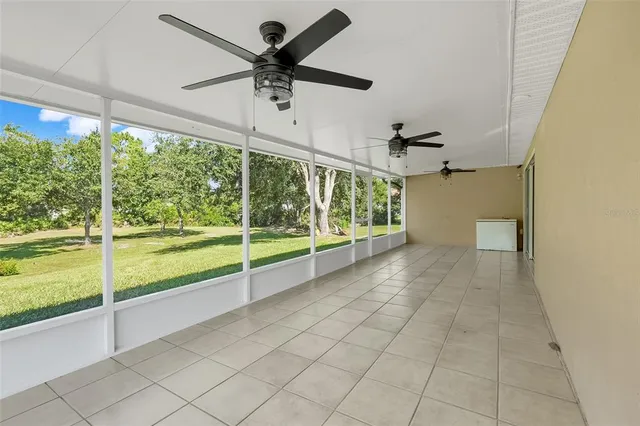 a view of a livingroom with a ceiling fan and a large window