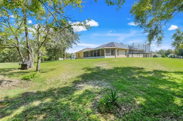 a view of an house with a big yard