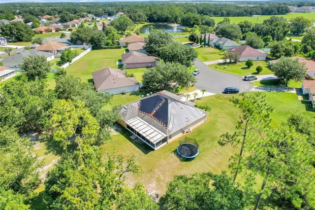 an aerial view of residential house with swimming pool and outdoor space