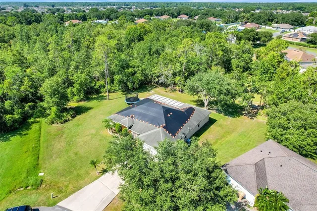 an aerial view of a house with a yard