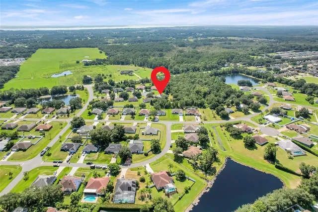 an aerial view of a residential houses with outdoor space and street view