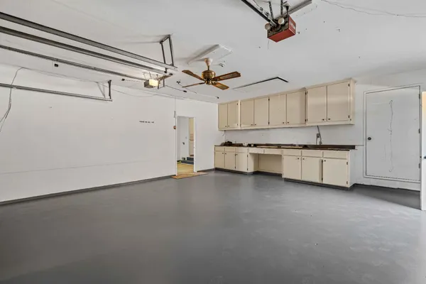 a view of a kitchen with a sink and cabinet