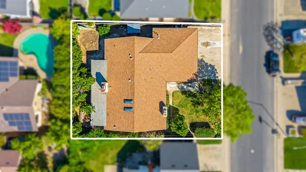 aerial view of a house with a yard and plants