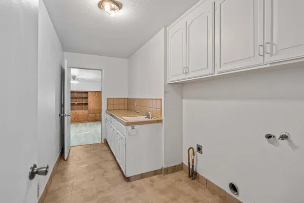 a view of a kitchen with fridge and wooden floor