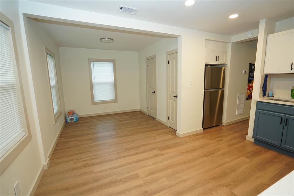 535 14th Avenue South, Unit W St. Petersburg, FL 33701 - Photo 11 of 15 a view of a kitchen with wooden floor and a refrigerator