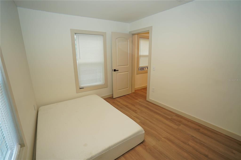 535 14th Avenue South, Unit W St. Petersburg, FL 33701 - Photo 12 of 15 a bedroom with a bed and wooden floor