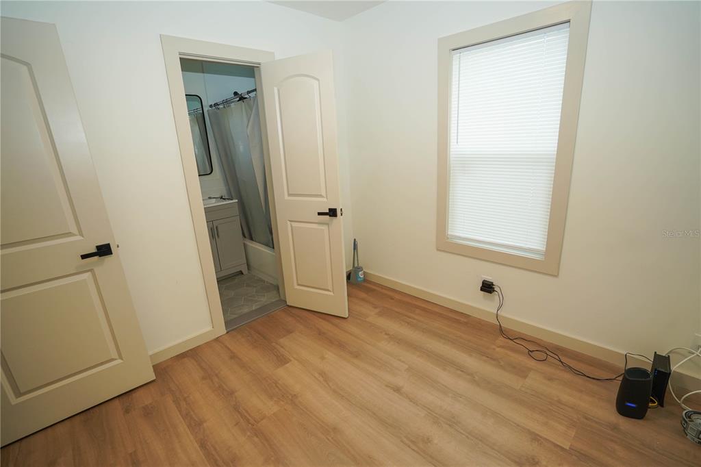 535 14th Avenue South, Unit W St. Petersburg, FL 33701 - Photo 14 of 15 an empty room with wooden floor and a window
