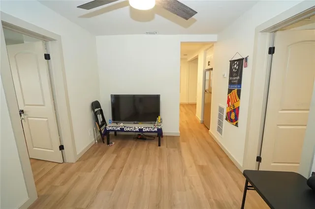a view of a bedroom with furniture and wooden floor
