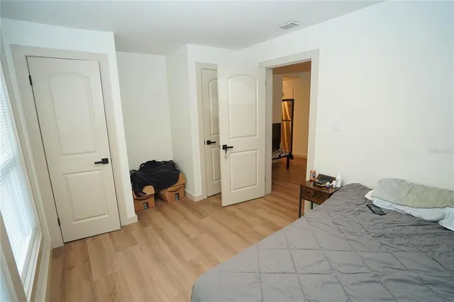 a bedroom with a bed and a chair