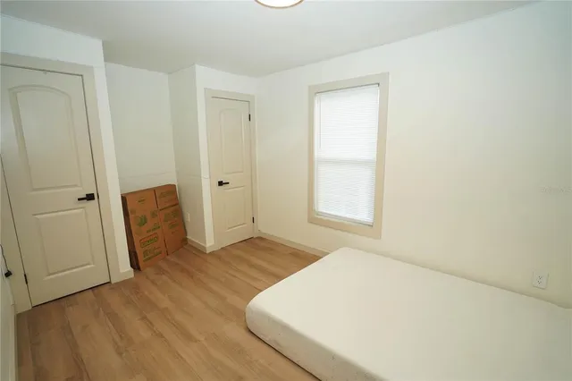 a view of empty room with wooden floor
