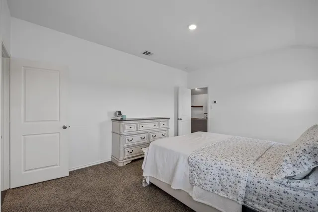 a bedroom with a bed and cabinets
