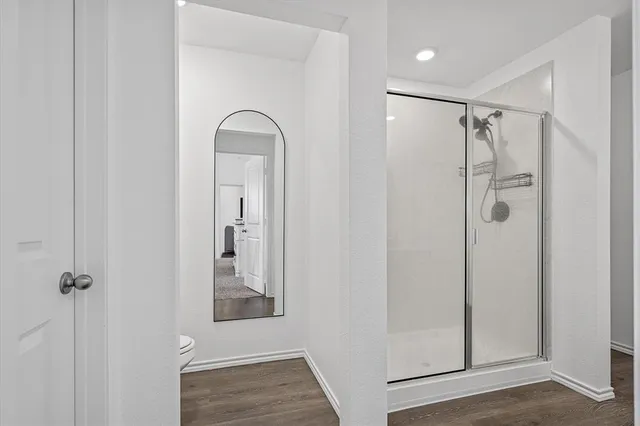 a view of a bathroom with a glass shower door