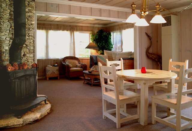 a dining room with furniture a chandelier and window